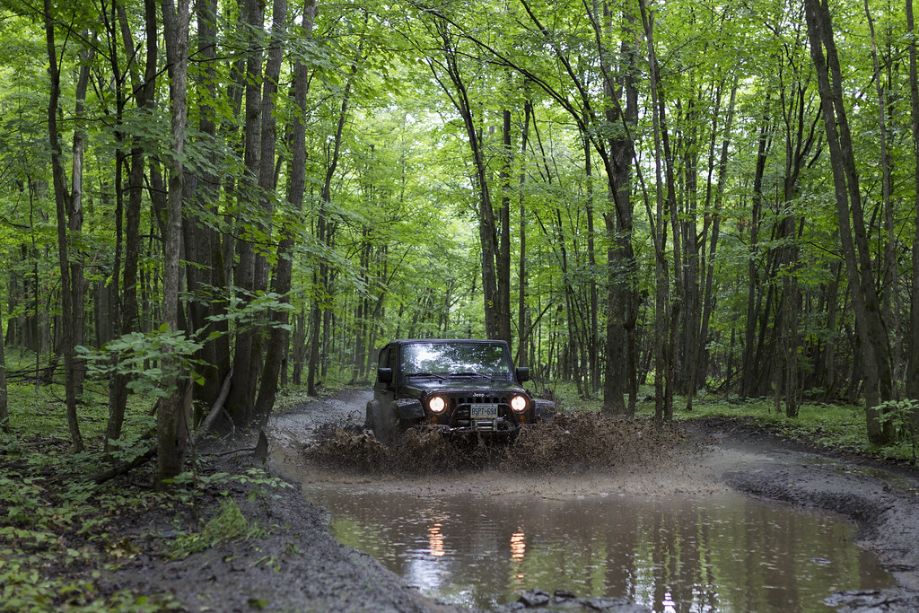 jeep driving through muddy trail
