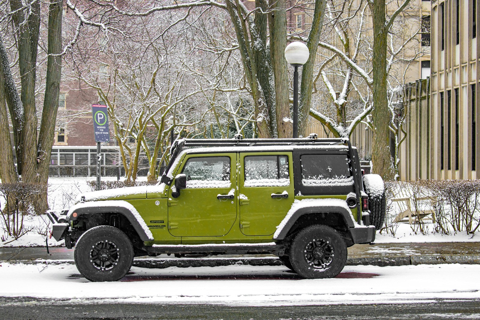 A green jeep parked on the side of the road