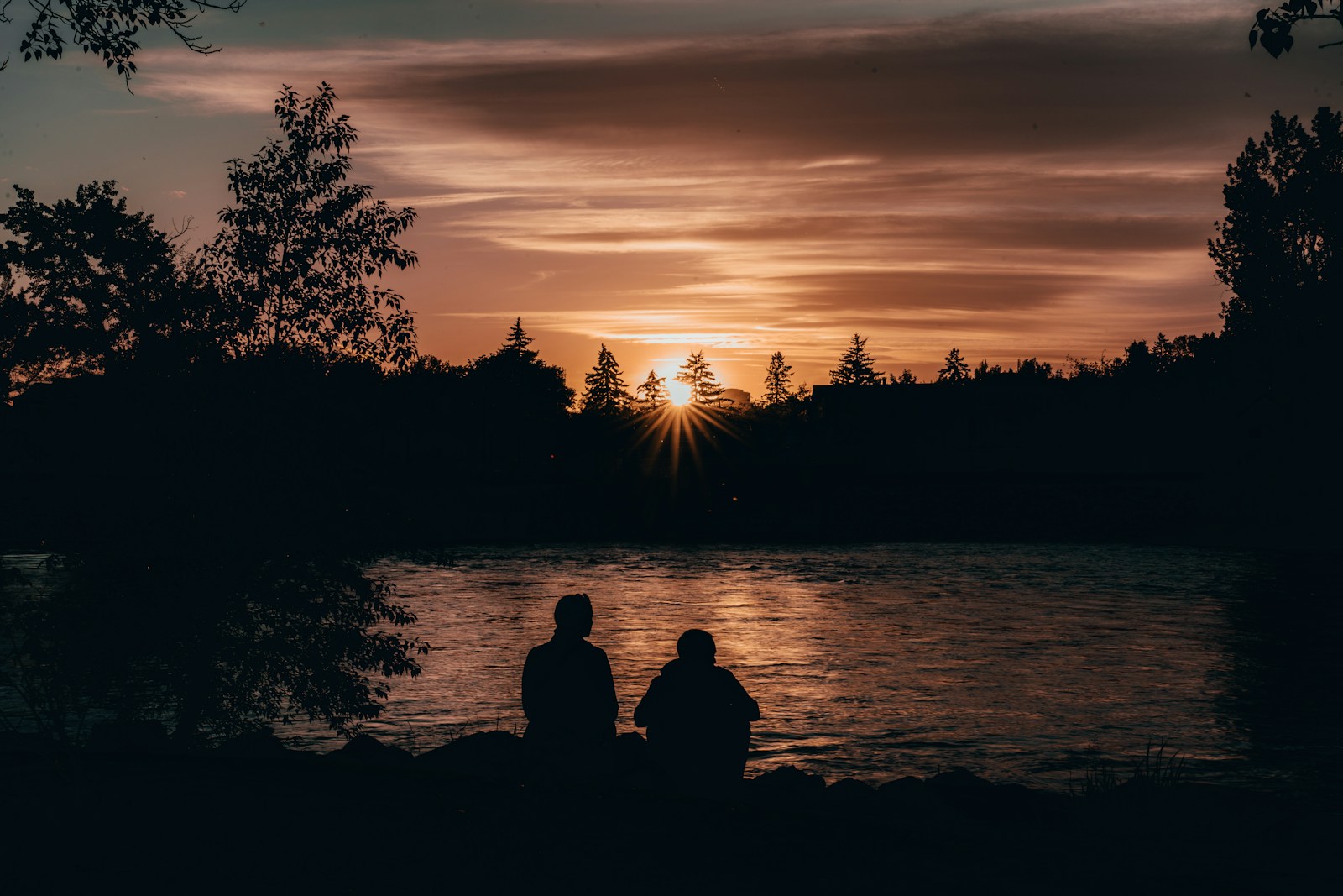 A couple of people sitting on top of a lake