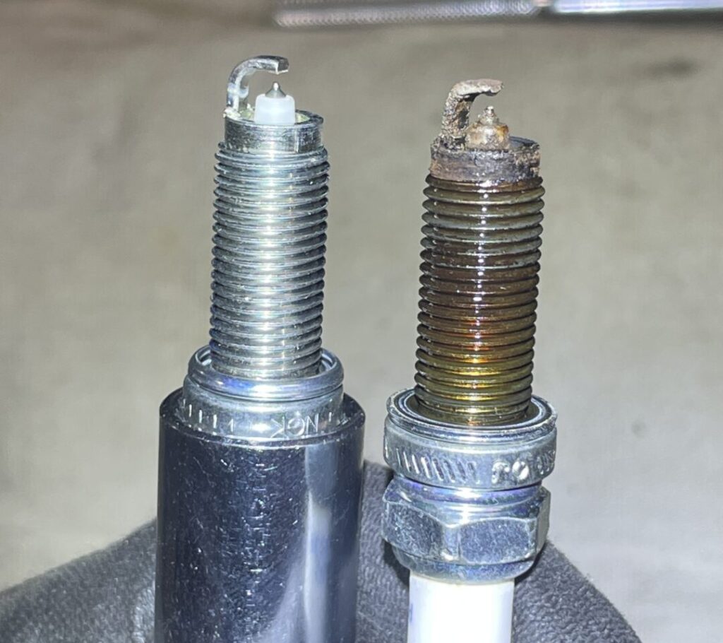 comparative view of old and new spark plugs