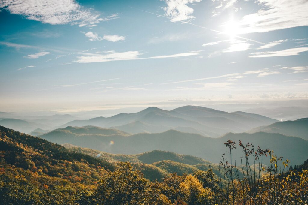smokey mountains under blue and white sky